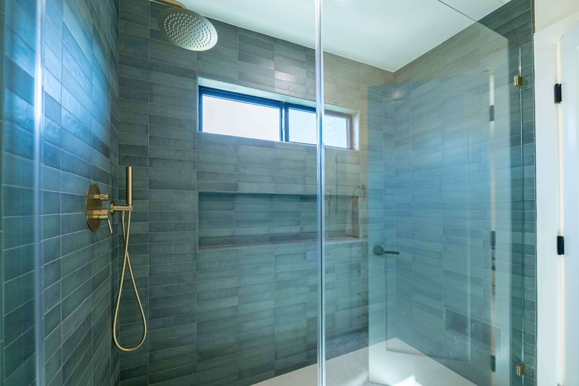 Walk-in shower with slate tile and brass rainhead