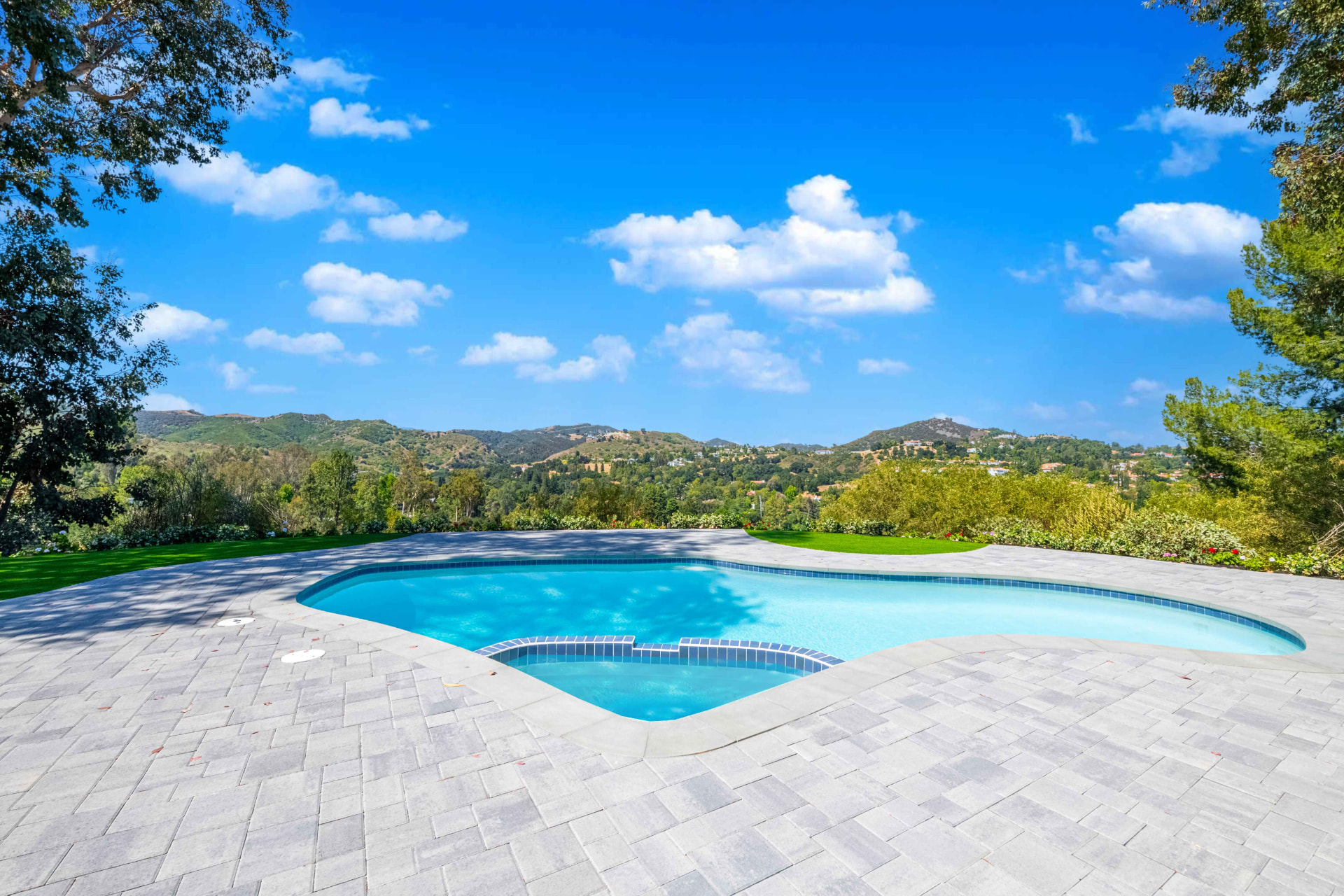 Stone paver pool deck with panoramic canyon views