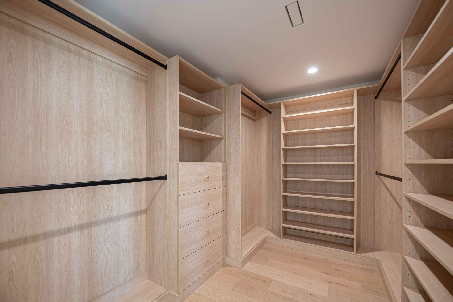 Custom white oak walk-in closet with matte black hardware